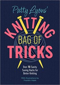 Cover of Knitting Bag of Tricks by Patty Lyons, black background with pink lettering and a ball of yarn with knitting needles stuck through it.