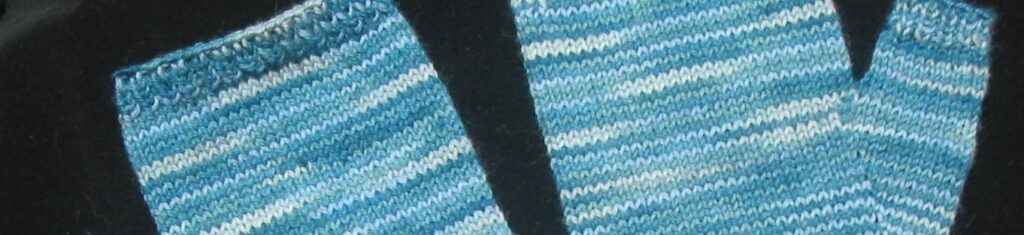 fingerless mitts partially shown, ocean blue against a black background